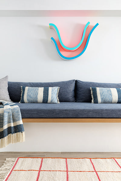 A Cool Wavy Sofa Actually Conceals Ductwork In This Family’s Brownstone Basement